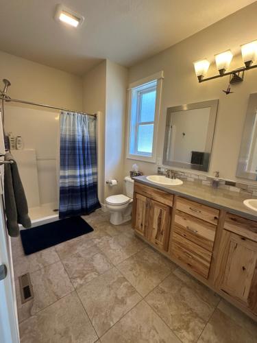 a bathroom with a sink and a toilet and a shower at Hometown Place in Missoula