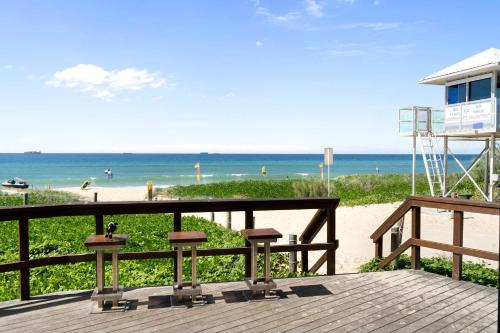 a wooden deck with a view of the beach at Bokarina Pool House - Relaxed Coastal Living in Bokarina