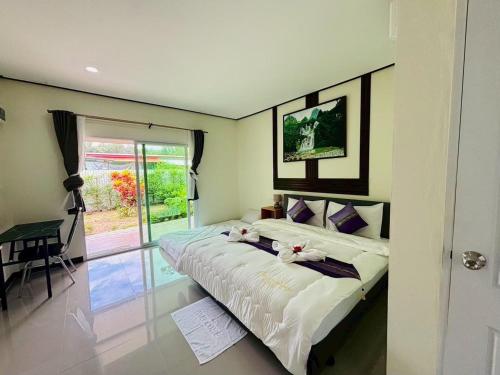a bedroom with a bed with flowers on it at 3P Phuket Airport Hotel in Phuket