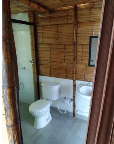 a bathroom with a toilet and a sink at Eco Ortalis Cabañas in Estación El Salto