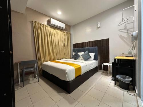 a bedroom with a bed and a sink and a desk at SS Grey Hotel BBKL in Kuala Lumpur