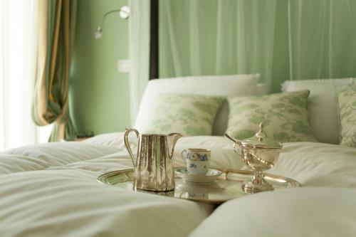 a tray with a tea set on a bed at Palazzo del Senatore in Atina