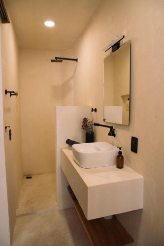 a white bathroom with a sink and a mirror at Casa Limon 2 bedrooms pool AC La Punta in Brisas de Zicatela