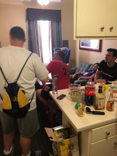 a group of people in a living room with a table at Davids Family Home in Bay Shore