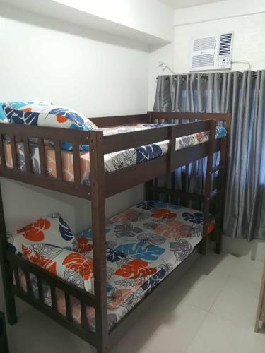 a bunk bed room with two bunk beds in a room at Serene Suites Condo unit in Bacoor