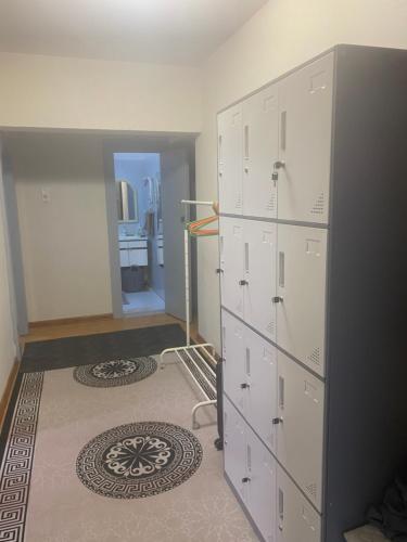 a room with white cabinets and a carpet at Хостел в центре Улан-Батора in Ulaanbaatar