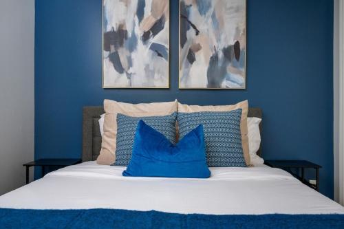 a blue bedroom with a bed with blue walls at The Serene Escape, 5 minutes to ATL airport in Atlanta