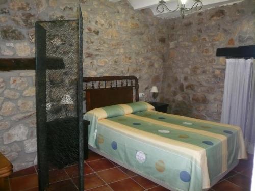a bedroom with a bed and a mirror at Loft Cuco in Puebla de Benifasar