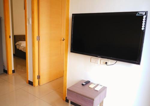 a flat screen tv hanging on a wall in a room at Extremeli Suites in Manila