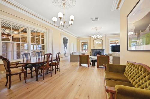 a living room with a table and chairs and a couch at Cornhill - Merrijig - Sleeps 12 in Merrijig