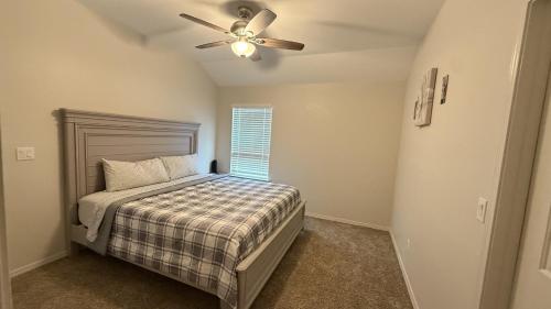 a bedroom with a bed and a ceiling fan at Comfortable new house in Homestead Meadows South