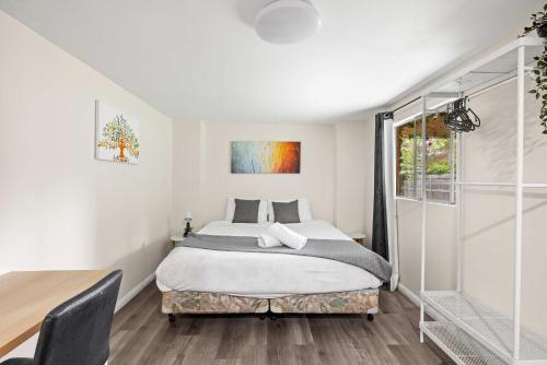 a bedroom with a bed and a window at Spacious King Studio Room in Carramar - Nearby Station & Shops - Shared Bathroom and Kitchen in Villawood