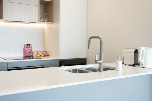 a kitchen with a sink and a counter top at Mountain View Woden Apt, Hospital, Westfield in Phillip