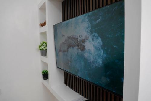 a flat screen tv hanging on a wall at Modern Guest House 2BR in Nakuru