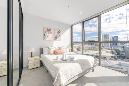 a bedroom with a bed and a large window at Mountain View Woden Apt, Hospital, Westfield in Phillip