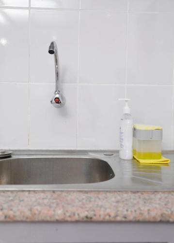 a kitchen sink with a bottle of detergent next to it at Modern Guest House 2BR in Nakuru
