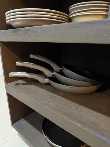 a shelf with plates and bowls in a cabinet at Villa Verde 2 Casa 14 in Tamarindo