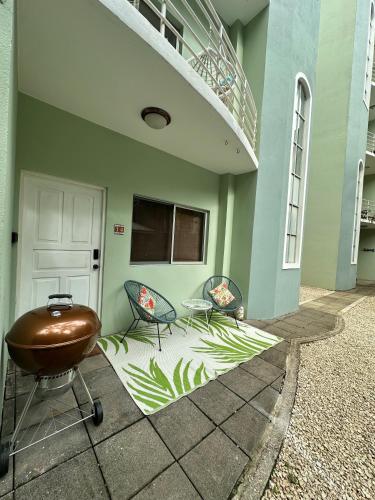 a patio with two chairs and a stair case at Villa Verde 2 Casa 14 in Tamarindo