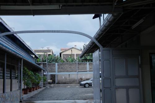 an empty parking lot with a car parked in a garage at Modern Guest House 2BR in Nakuru