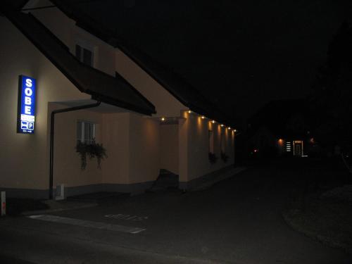 a sign on the side of a building at night at Apartmaji in sobe RaMar in Straža