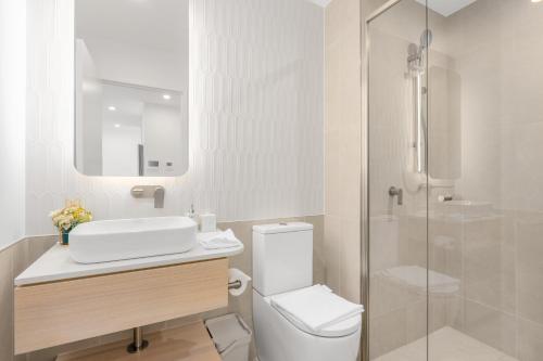 a bathroom with a toilet and a sink and a shower at Cozy Woden Stay, Hospital, Mall, Pool, Parking in Phillip