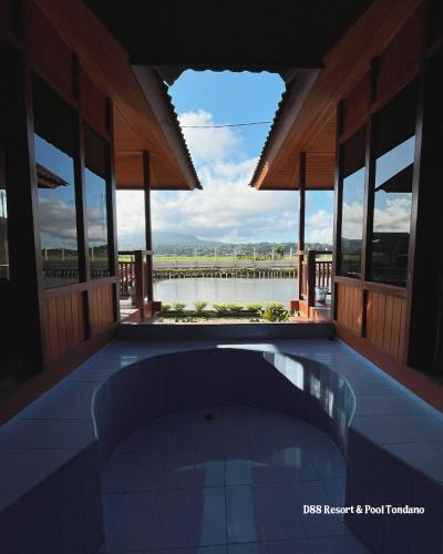 a swimming pool in a house with a view of the water at D88 Resort in Remboken