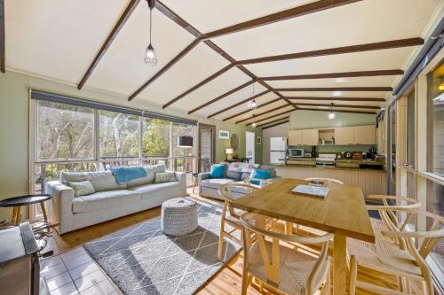 a living room with a table and chairs at High Road Haven in Halls Gap