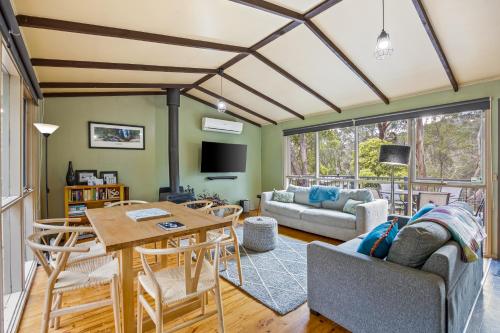 a living room with a table and chairs at High Road Haven in Halls Gap