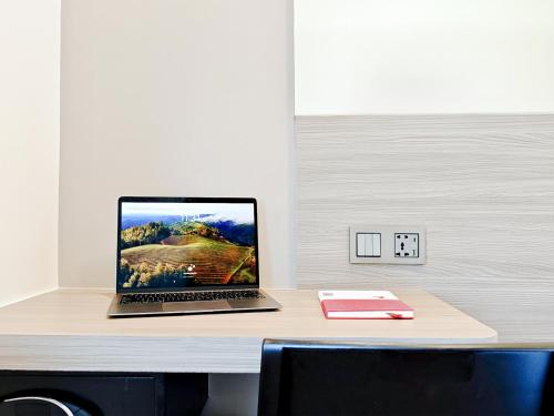 a laptop computer sitting on top of a desk at Red Planet Manila Aseana City in Manila
