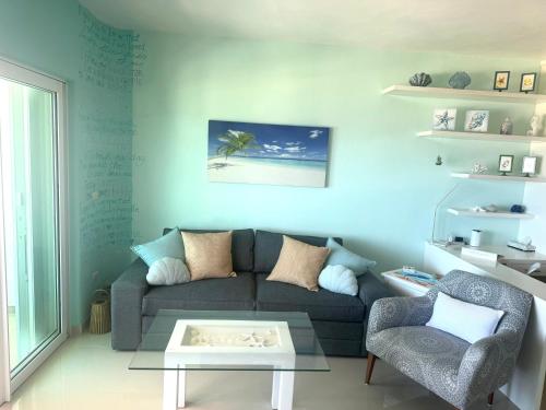 a living room with a couch and a table at Casa Frida - Beachfront Ocean View in Puerto Morelos