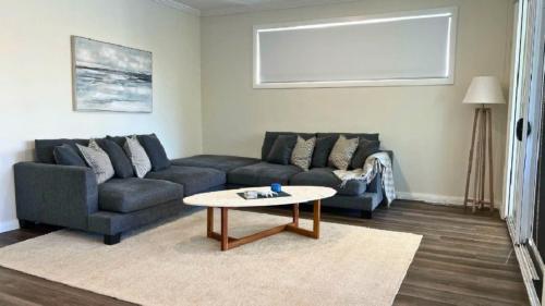 a living room with a couch and a coffee table at La Dolce Vita in Sussex inlet
