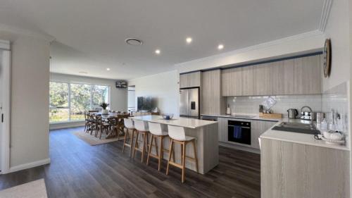 a kitchen with a counter and a dining room at La Dolce Vita in Sussex inlet