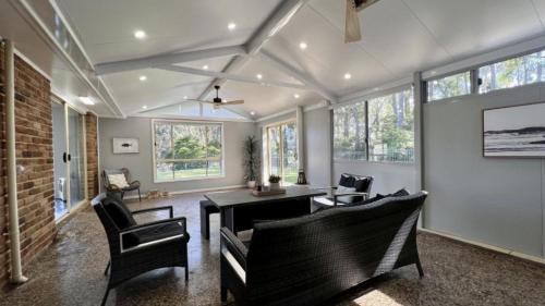 a living room with chairs and a table at The Quay To Sussex in Sussex inlet