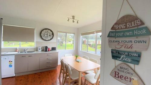 a kitchen with a table and a dining room at Greentree Sanctuary In South Sussex in Sussex inlet
