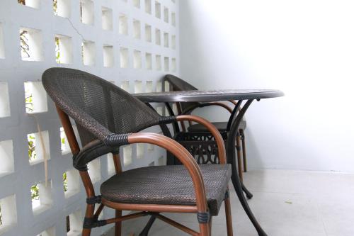 two chairs and a table in a room at Xen Pool Access in Chalong 