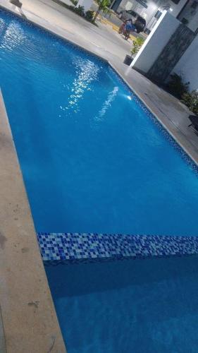 a large blue swimming pool with blue water at Luxurious pool apartment 5minutes from the airport in La Caleta
