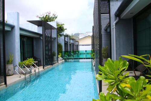 a swimming pool on the side of a building at Xen Pool Access in Chalong 