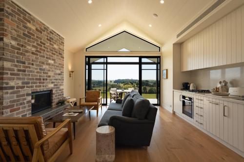 a living room with a couch and a fireplace at The Brooklet in Byron Bay