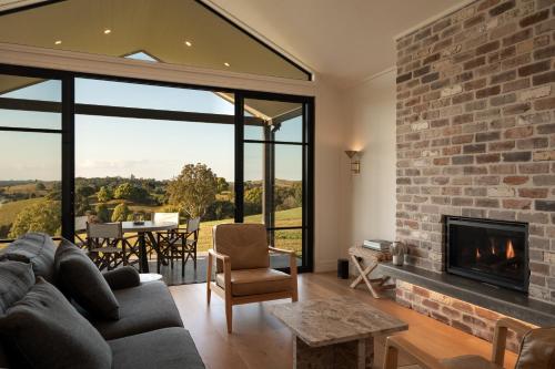 a living room with a couch and a fireplace at The Brooklet in Byron Bay