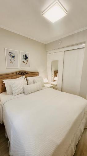 a white bedroom with a large white bed at Sao Paulo Ibirapuera Privilege - Suite Deluxe in Sao Paulo
