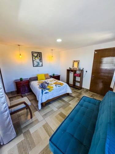 a bedroom with a bed and a couch at Casa Sac Nicte Tlalpujahua in Tlalpujahua de Rayón