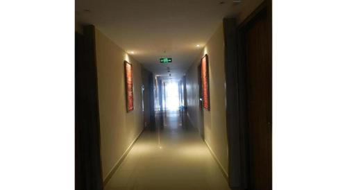 a long hallway with a light at the end at Wing Hotel Kualanamu Airport in Medan