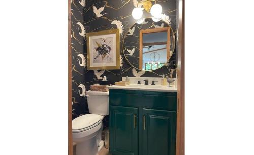 a bathroom with a green sink and a toilet at The Raven in Beech Mountain