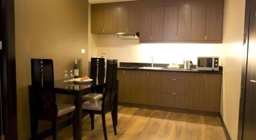 a kitchen with a table and chairs and a kitchen with a counter at F1 Hotel Manila in Manila