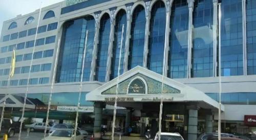 a large building with cars parked in front of it at The CentrePoint Hotel in Bandar Seri Begawan