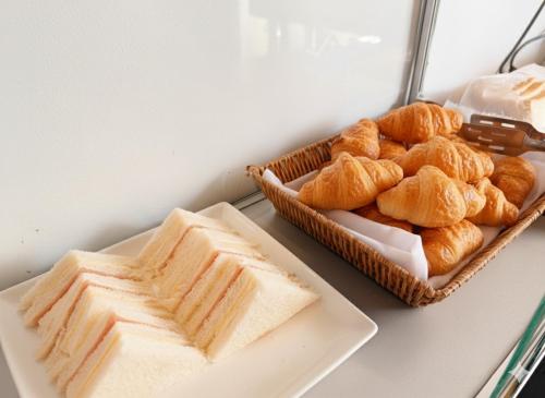 a table with two baskets of bread and pastries at Blu Monkey Hub & Hotel Surat Thani in Surat Thani