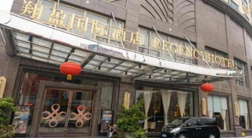 a building with a sign on the front of it at Regency Hotel in Dongguan
