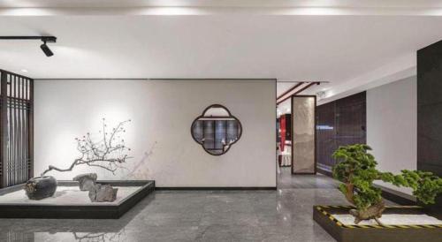 a living room with a table and some plants at Dengfeng Chanwu Hotel in zhengzhou