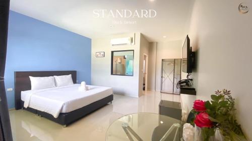 a bedroom with a bed and a glass table at Rock Resort in Ratchaburi
