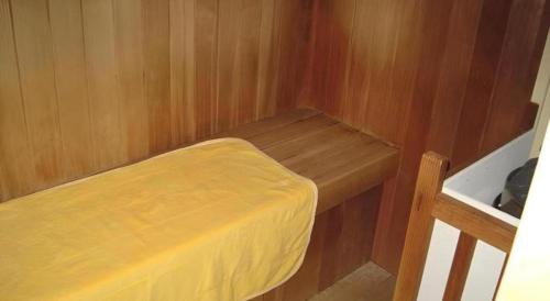 a small room with a small bed in a boat at Hotel Kaijyokan in Tosashimizu